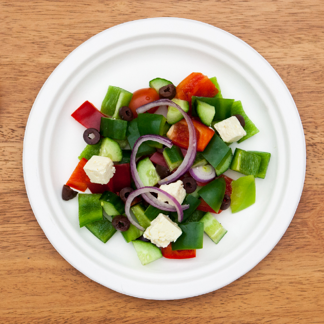 Round Bagasse Plate serving Greek Salad